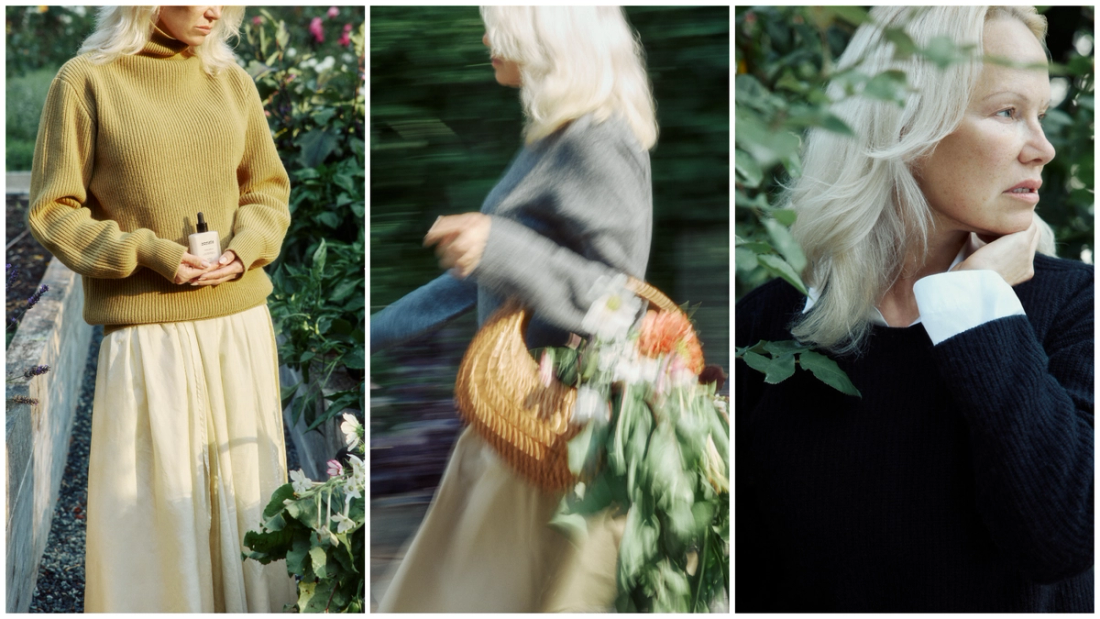Pamela Anderson in a garden wearing a mustard sweater and holding Sonsie Skin skin care; walking with a flower-filled basket; close-up profile showing bare, natural skin.