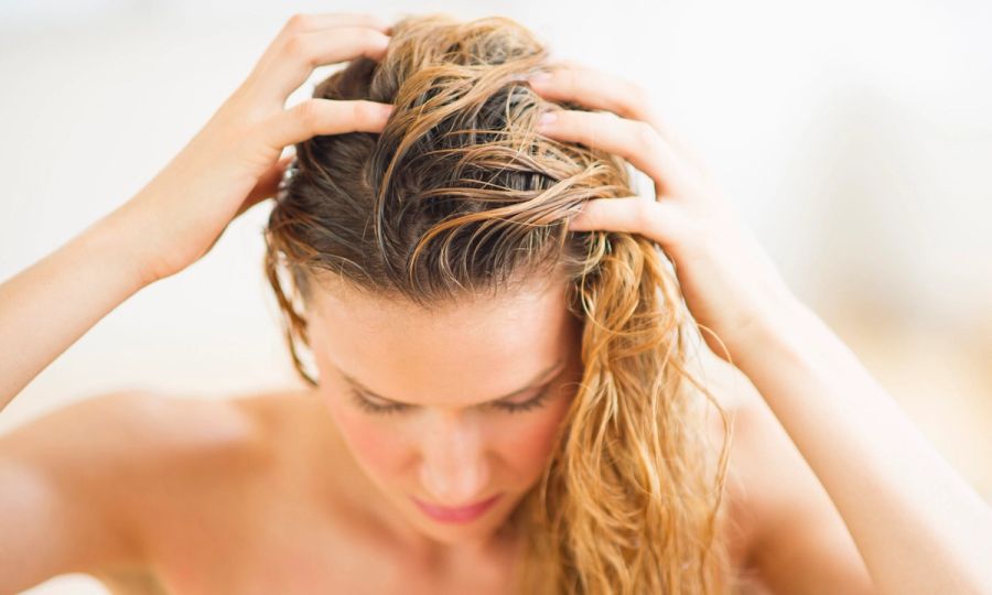 woman touching hair and scalp