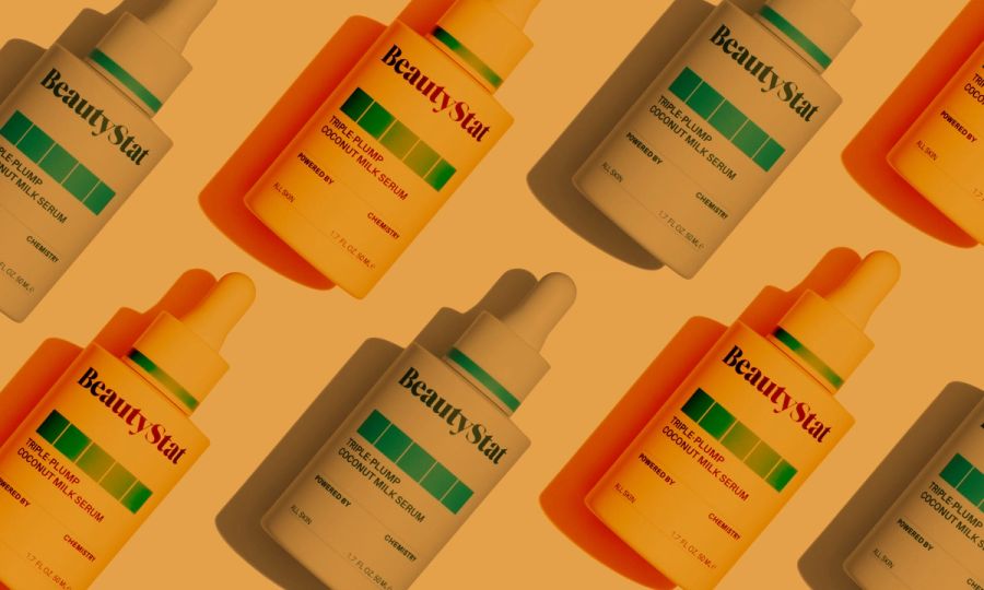 Beauty Stat Triple-Plumping Coconut Milk Serum bottles on orange background