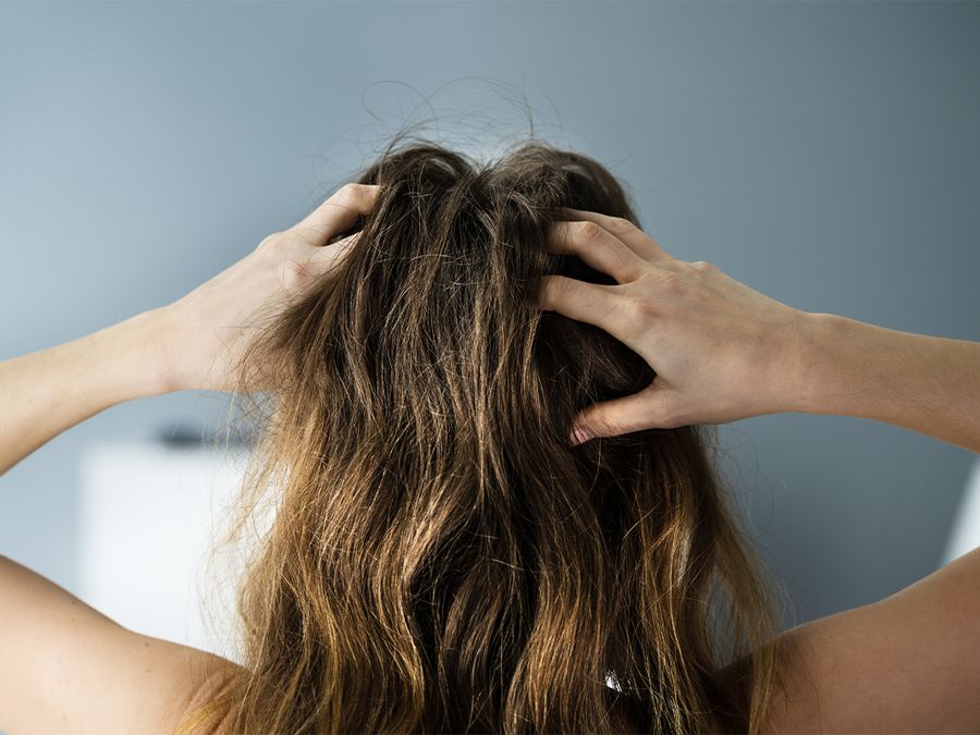 back view of woman with hands in her hair