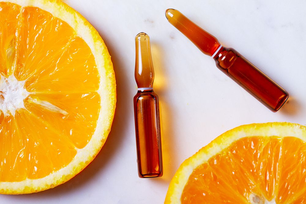 Vitamin C, natural treatment concentrate with slice of fresh orange fruits concept, top view