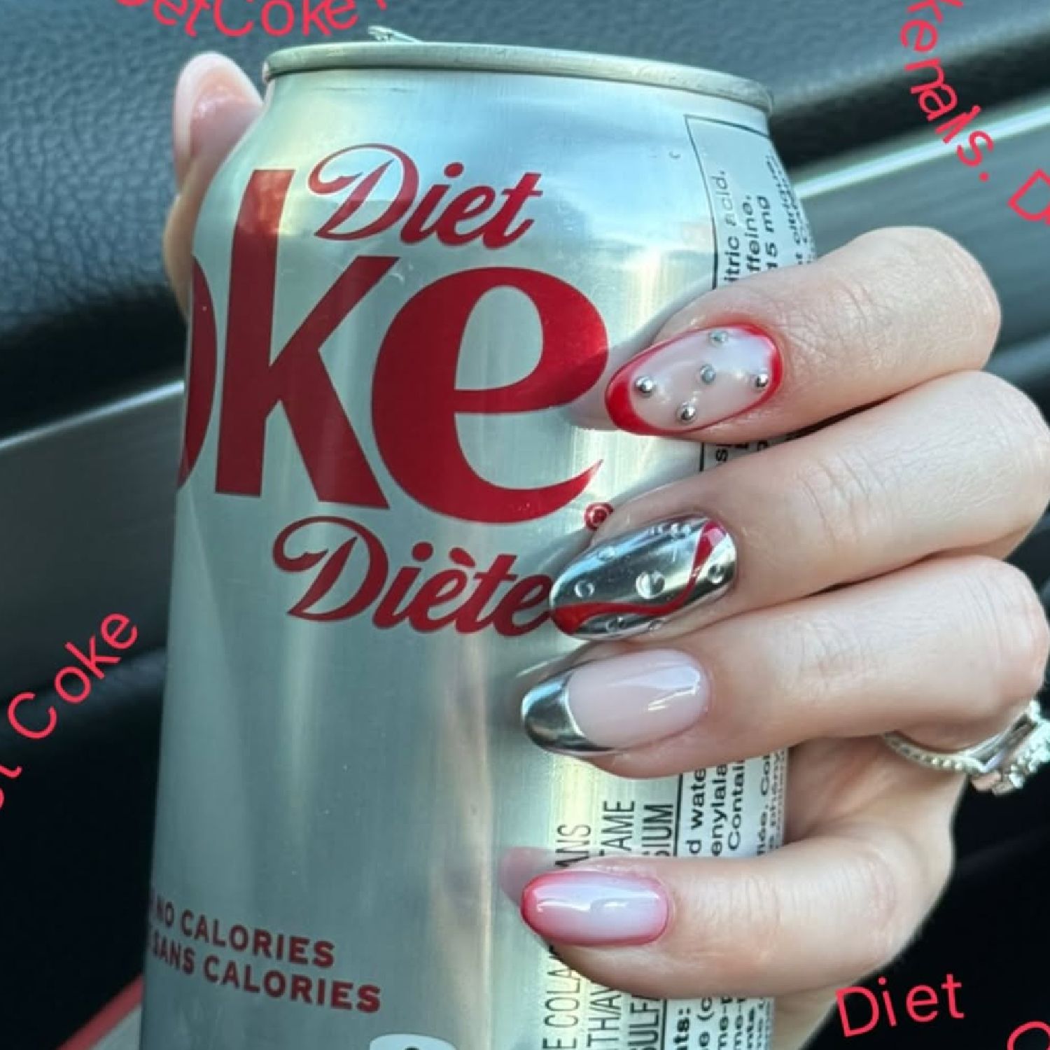 Diet Coke nail art with chrome silver nails, red tips and pearl stud accents creating a textured, bubble-inspired manicure while holding a Diet Coke can