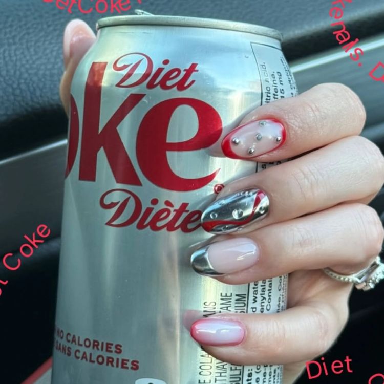 Diet Coke nail art with chrome silver nails, red tips and pearl stud accents creating a textured, bubble-inspired manicure while holding a Diet Coke can