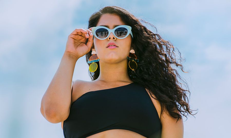 Young confident woman standing on the beach