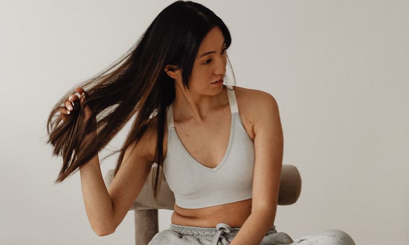 woman sitting in chair with hand in her hair