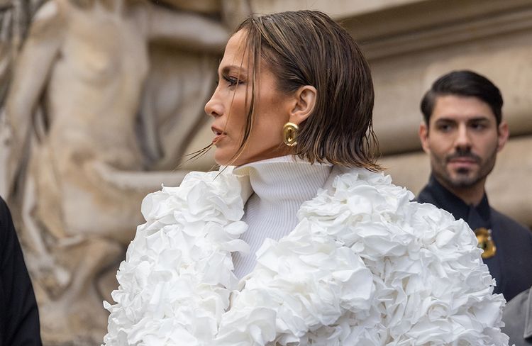 Jennifer Lopez in white couture coat and white turtleneck with a wet-style bob