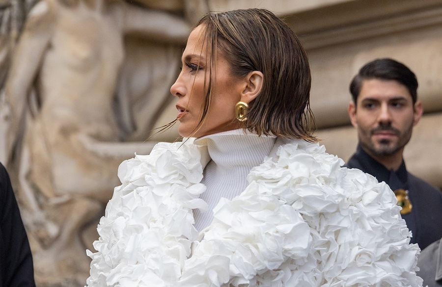 Jennifer Lopez in white couture coat and white turtleneck with a wet-style bob