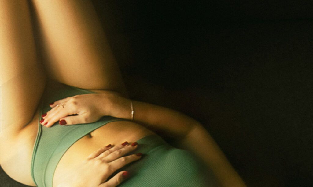 lower body of woman in green bralette and underwear
