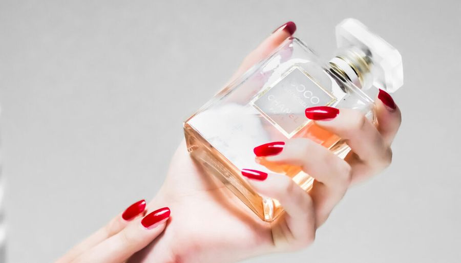 woman holding coco chanel fragrance