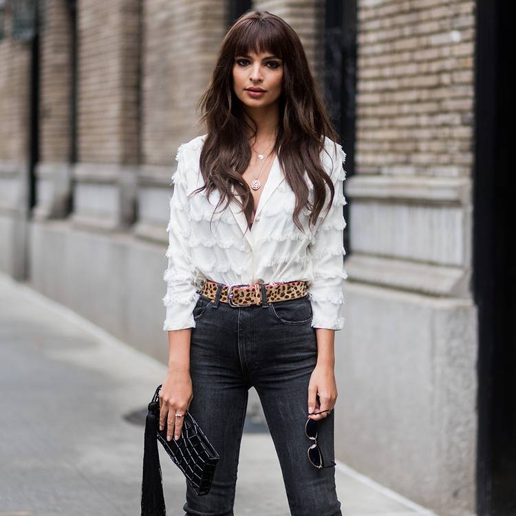 Emily Ratajkowski posing on the street with long brown hair and bangs