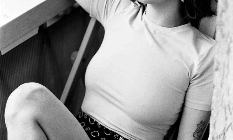 black and white photo of woman's chest in white t-shirt