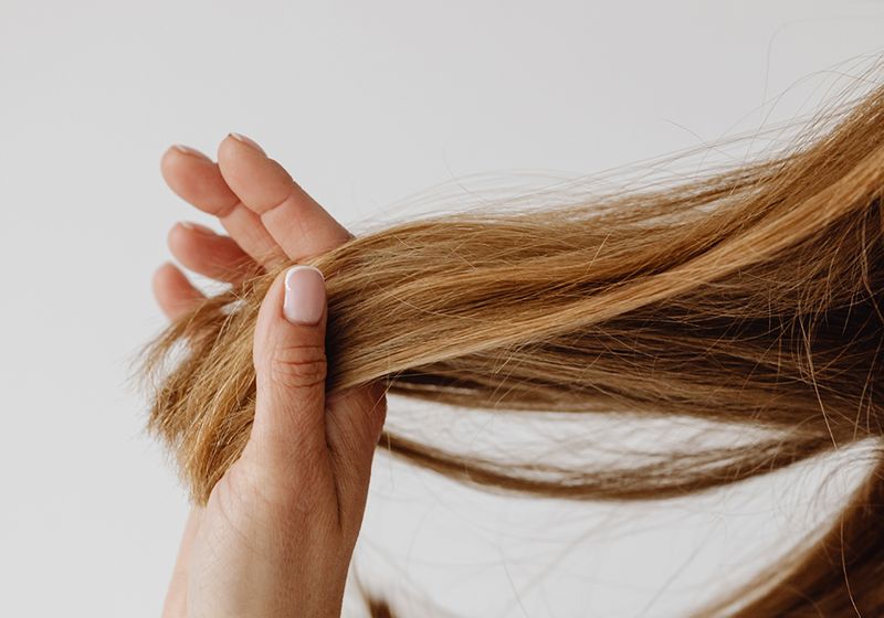 woman running fingers through hair ends