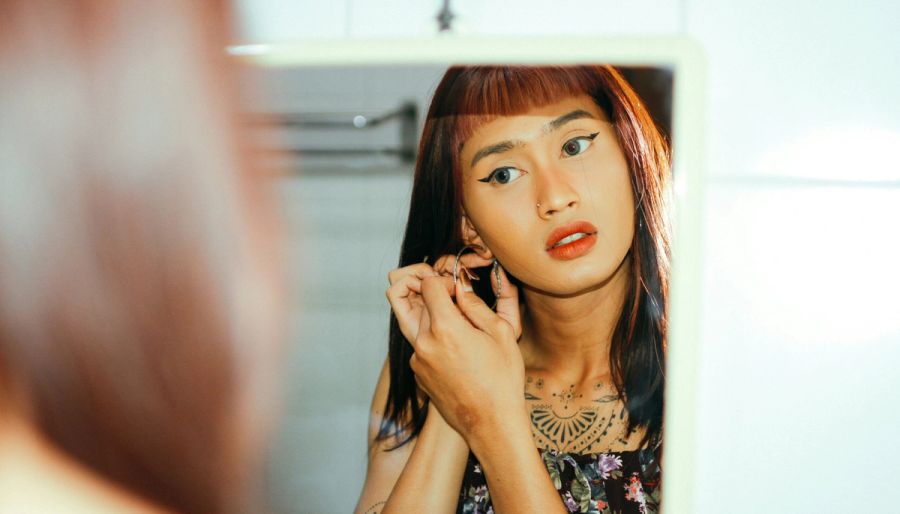 woman looking at herself in the mirror