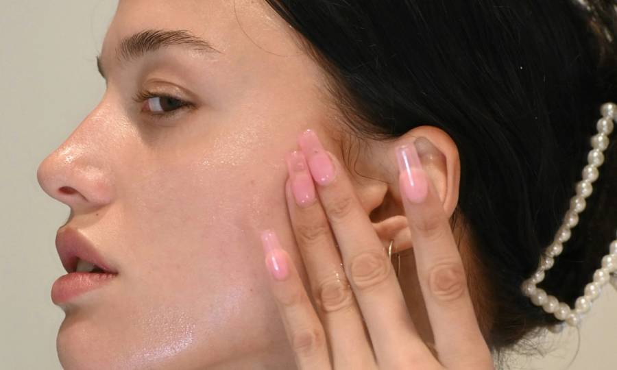 woman applying skin care serum