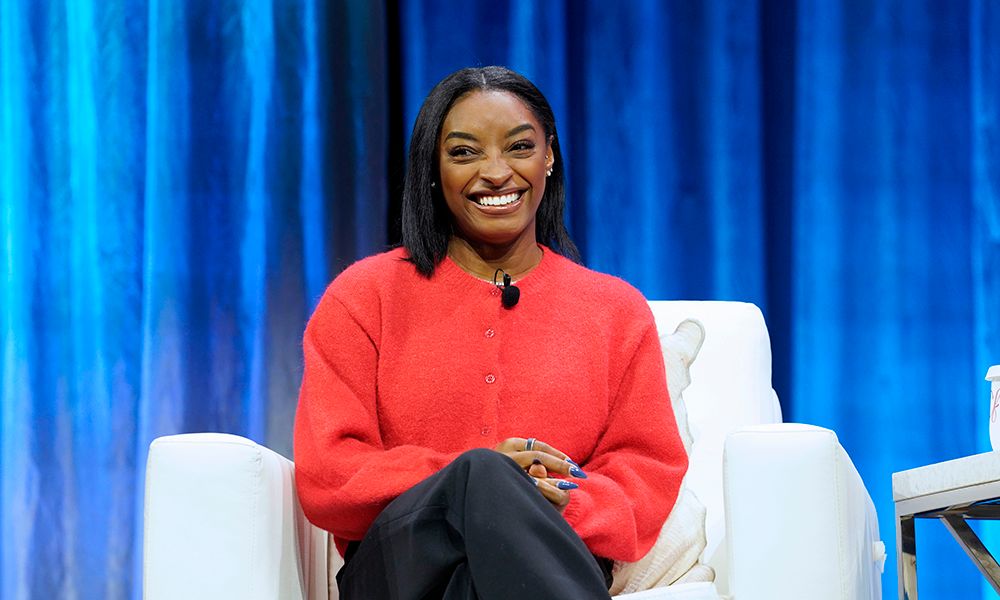 BOSTON, MASSACHUSETTS - DECEMBER 03: Simone Biles, Athlete and Advocate speaks on stage during 2025 Massachusetts Conference for Women at Boston Convention and Exhibition Center on December 03, 2025 in Boston, Massachusetts.