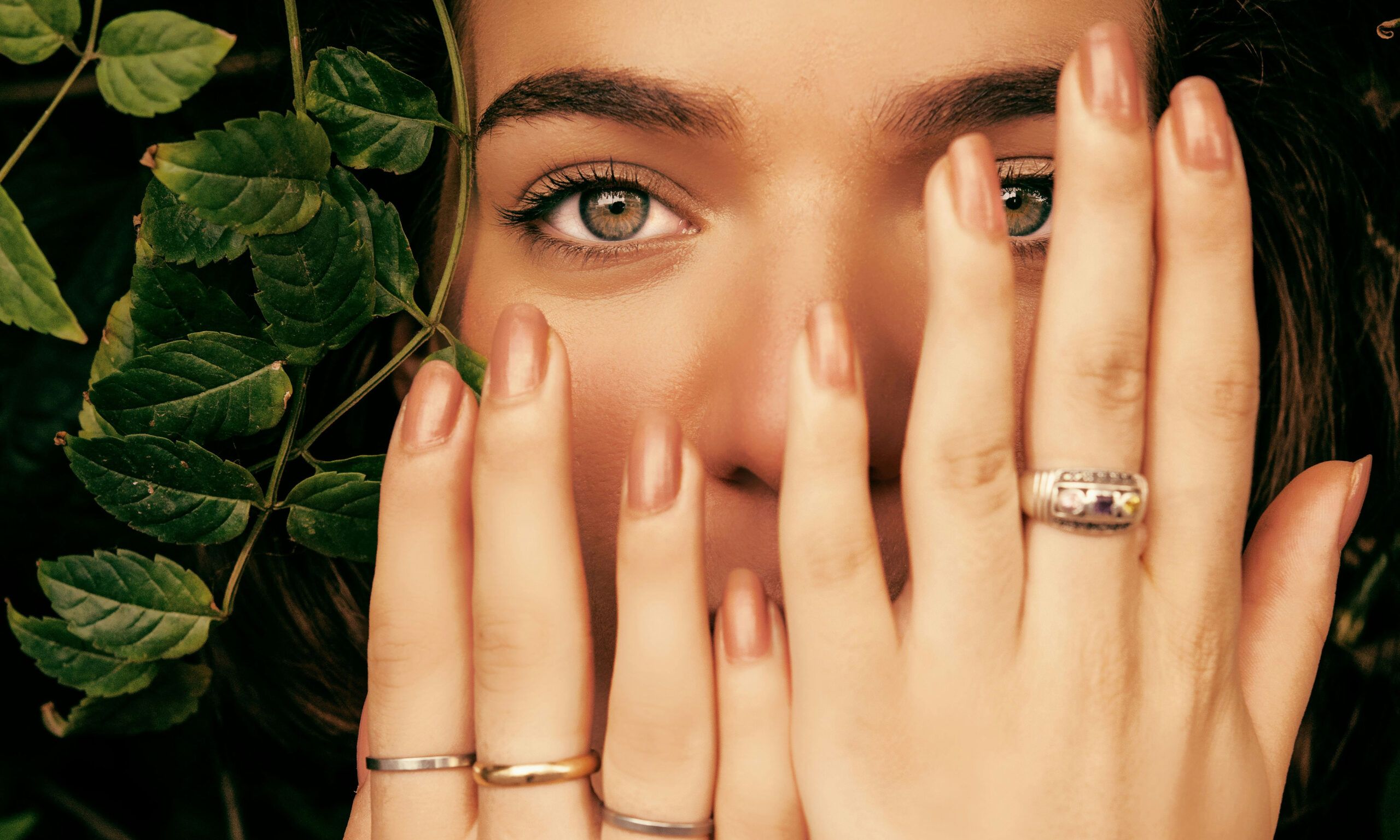 woman with hands in front of her face with manicured hands