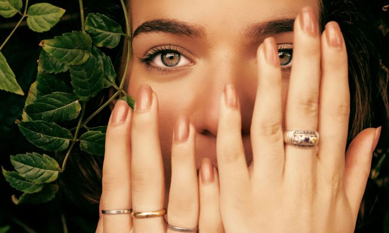 woman with hands in front of her face with manicured hands