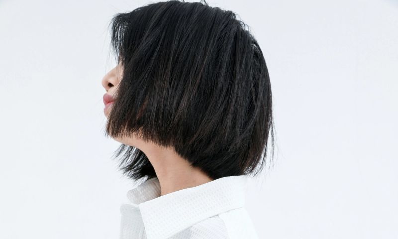 side view of woman with short black bob