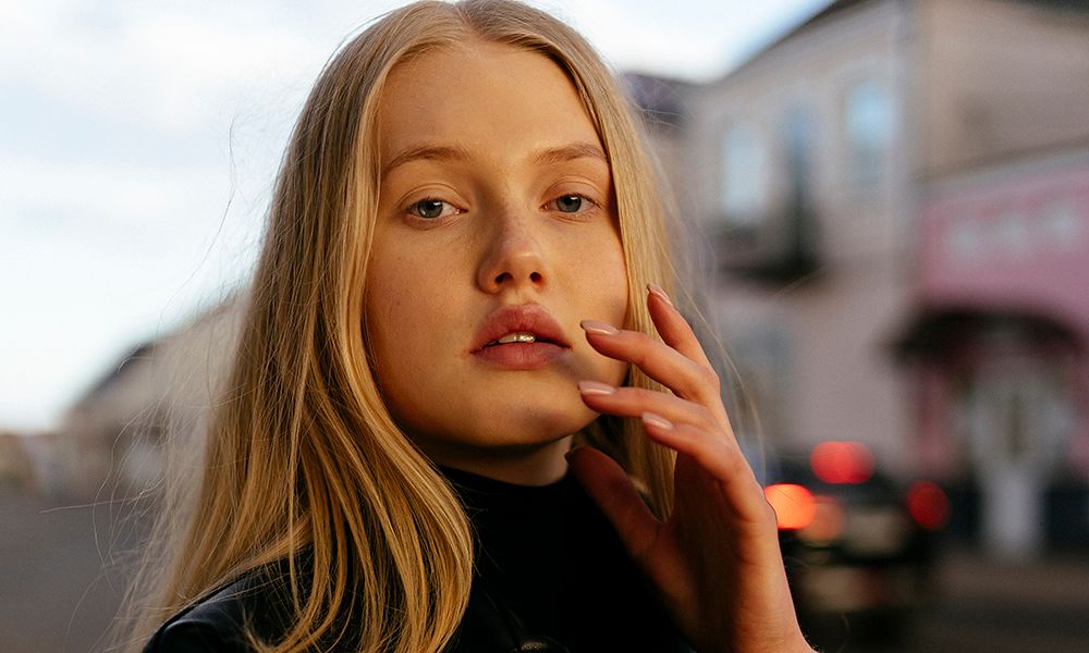 Stylish blonde woman with in leather black jacket