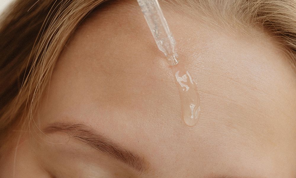 skin serum on forehead