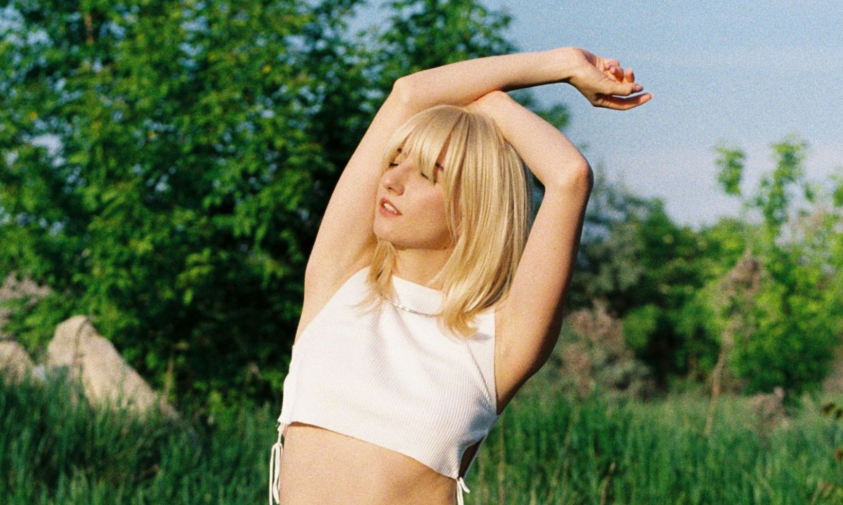woman with mid-length blonde hair outdoors