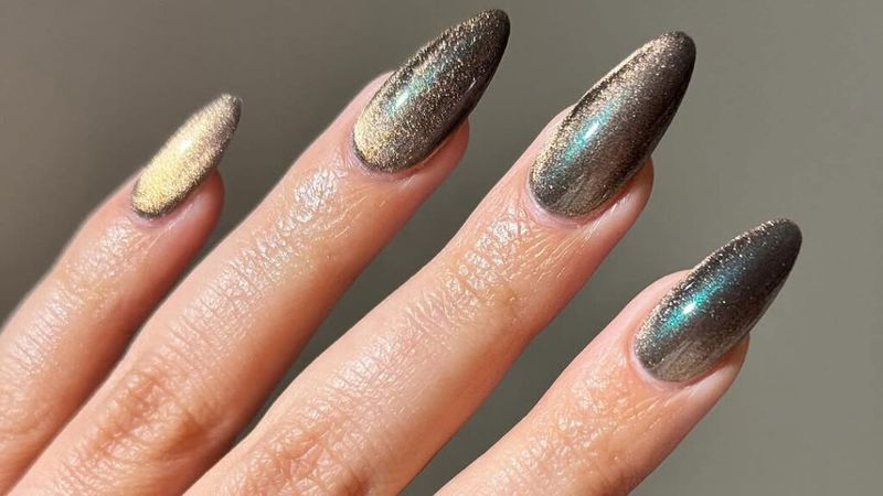 A manicure with olive green cat eye design