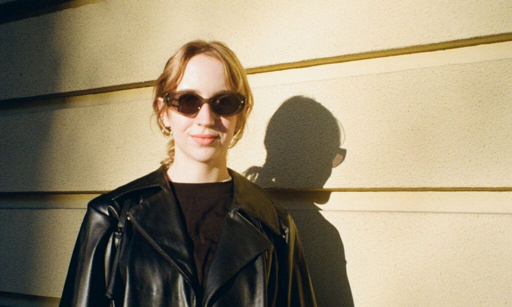woman in black leather jacket and black sunglasses in sunlight