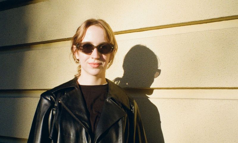 woman in black leather jacket and black sunglasses in sunlight