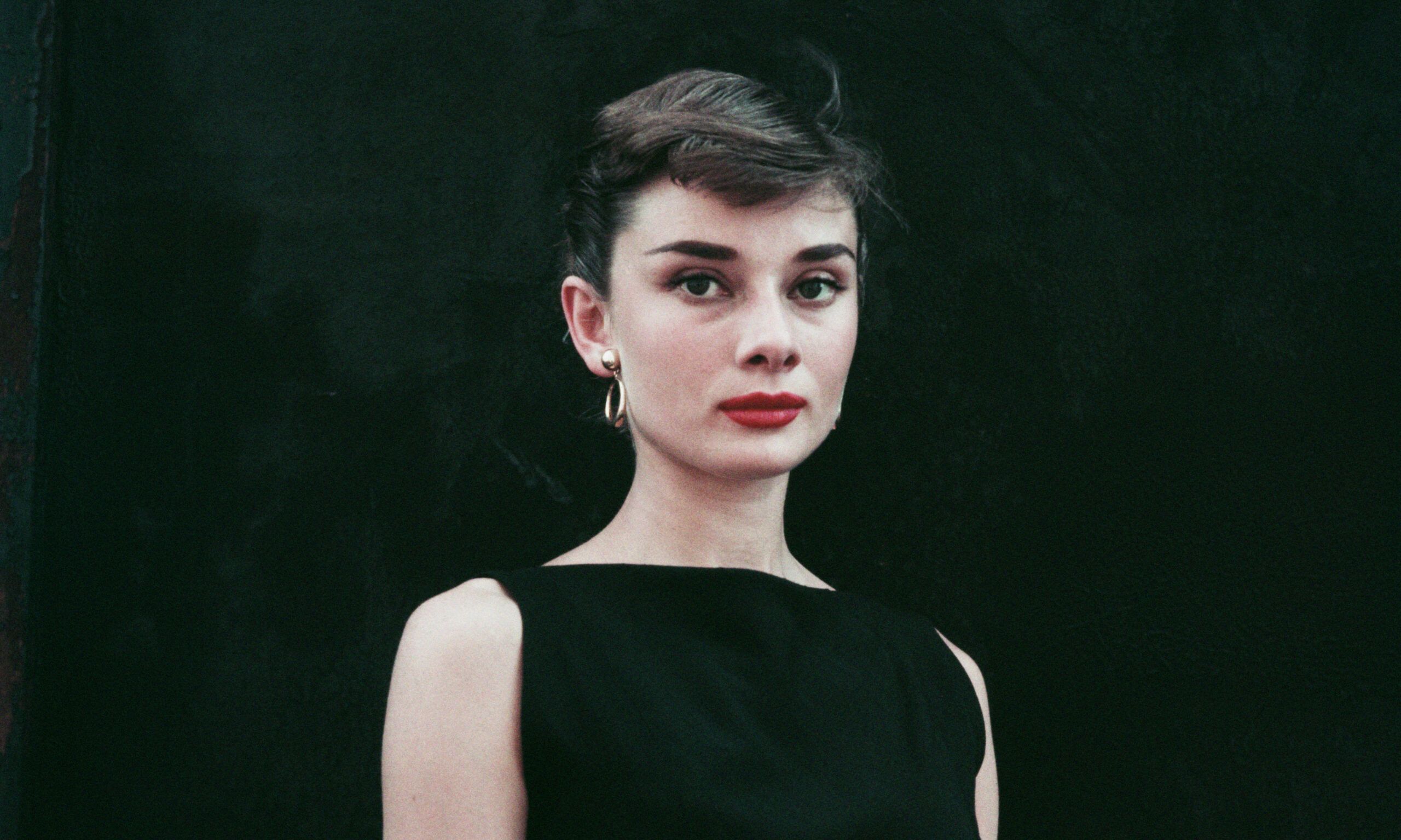 Belgian-born actress Audrey Hepburn (1929 - 1993) in a black sleeveless dress, circa 1955.