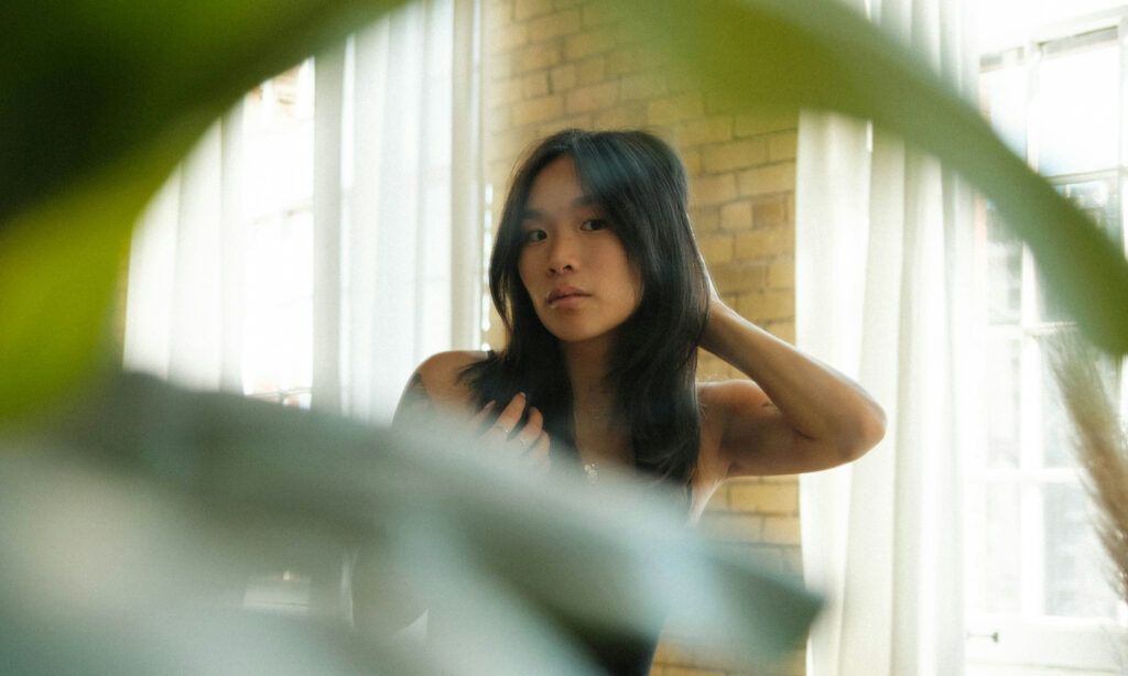 woman looking at her hair