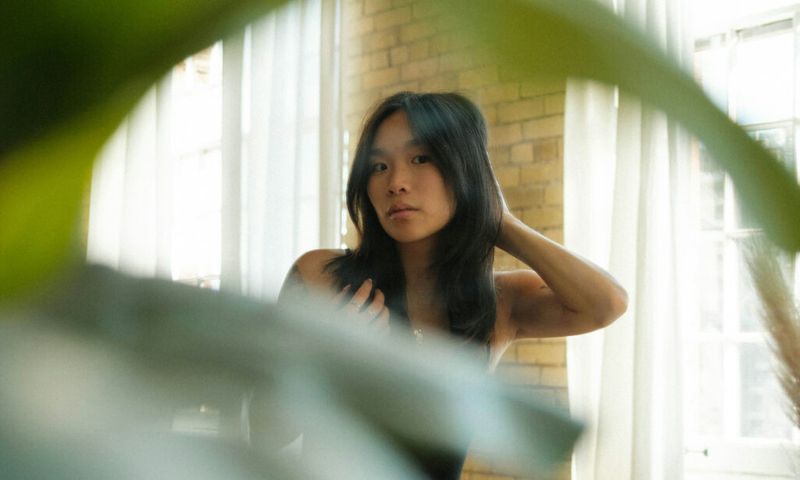 woman looking at her hair