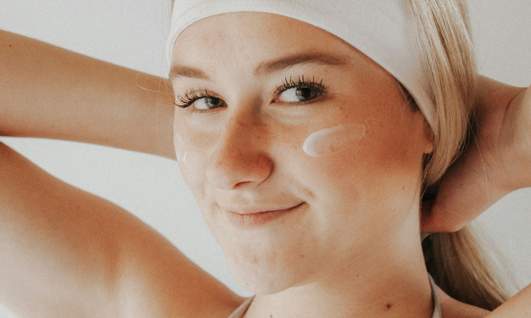 woman with face cream on her cheeks