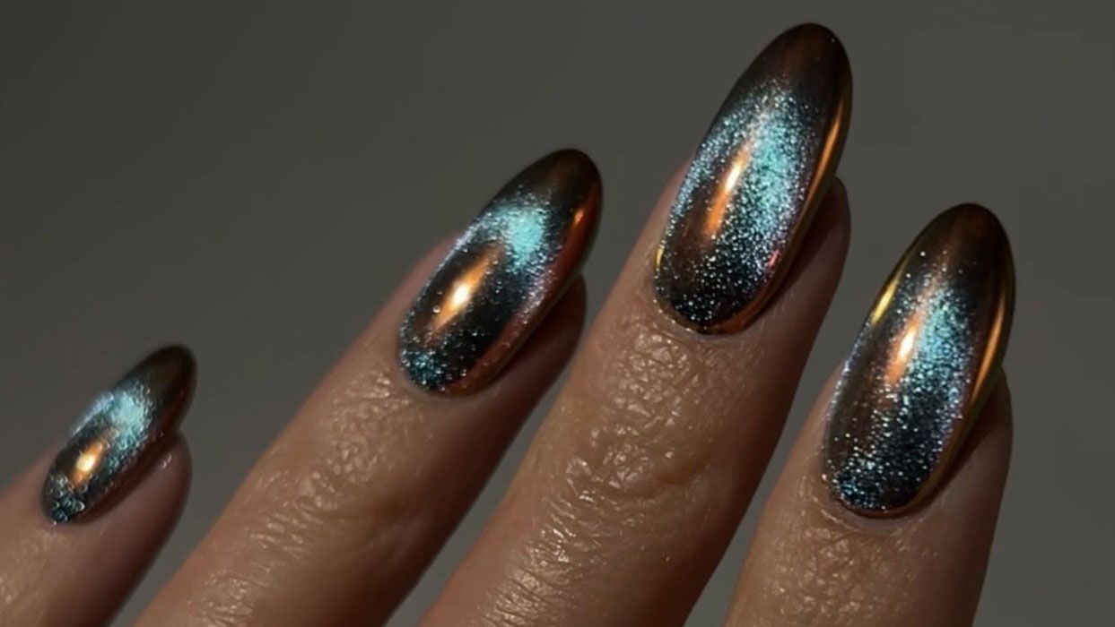 a close up of blue sand nail design