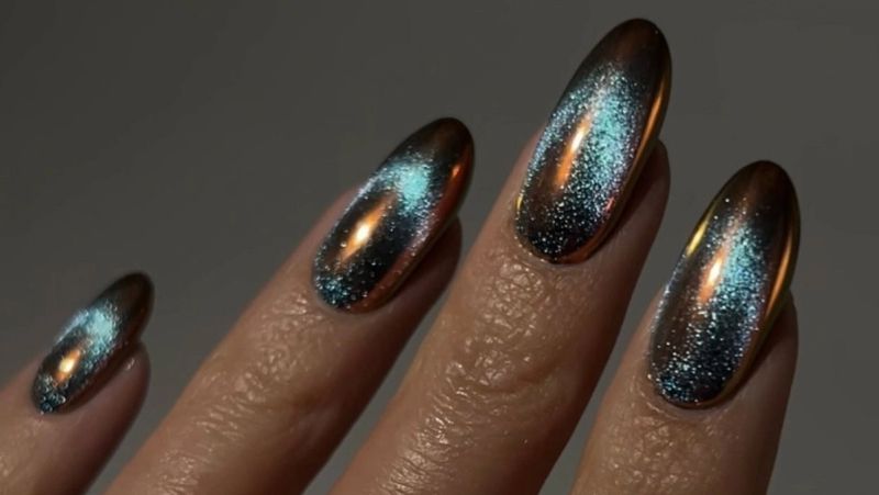 a close up of blue sand nail design