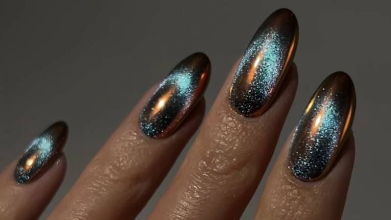 a close up of blue sand nail design
