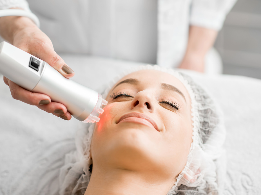 woman receiving cosmetic treatment on face