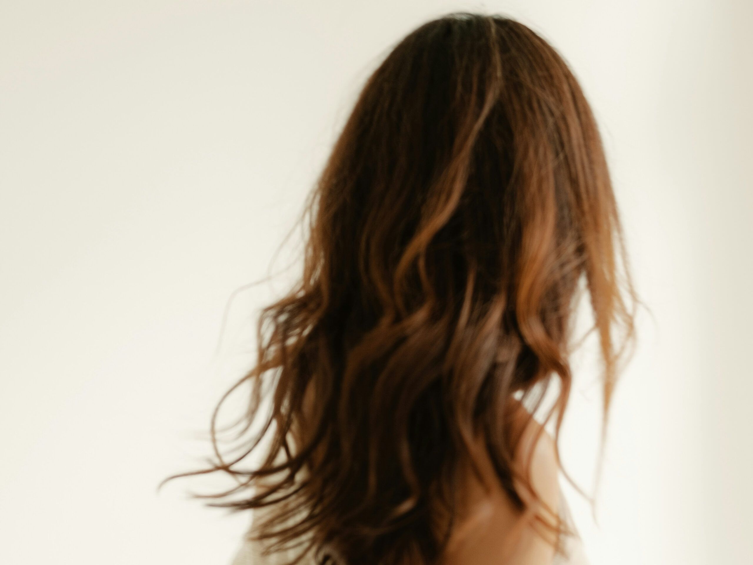 back view of woman with brown wavy hair