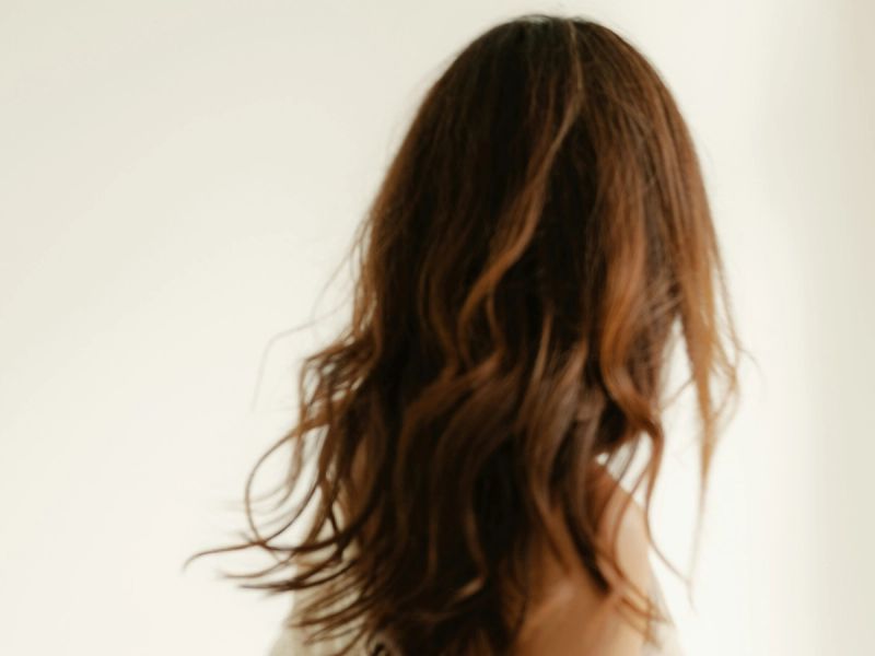 back view of woman with brown wavy hair