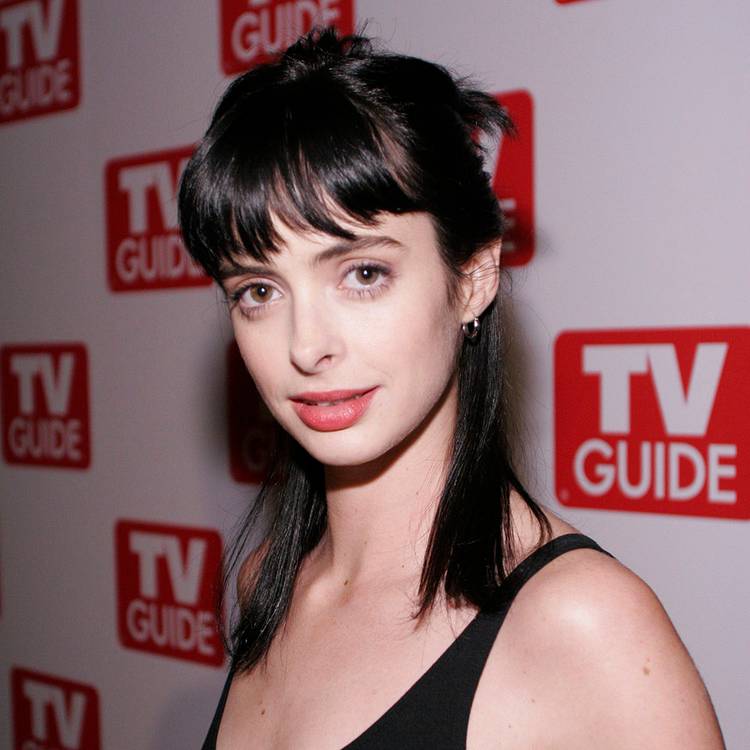 Krysten Ritter on the red carpet with brown short hair and bangs