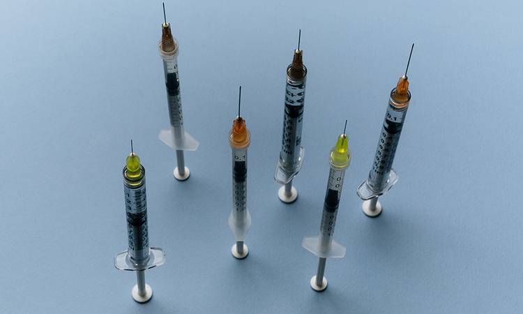 injections on blue background