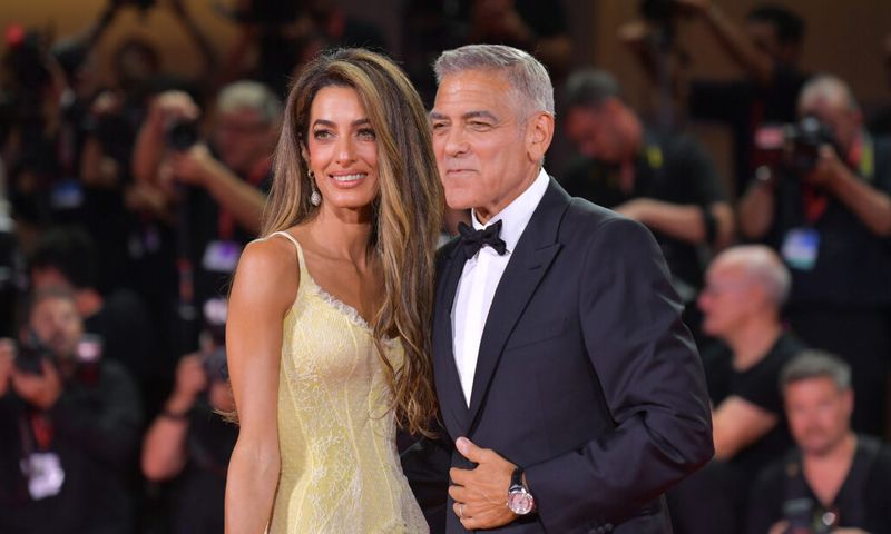 Amal Clooney and George Clooney attend the "Wolfs" red carpet during the 81st Venice International Film Festival .