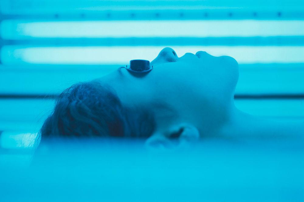 woman in blue tanning bed
