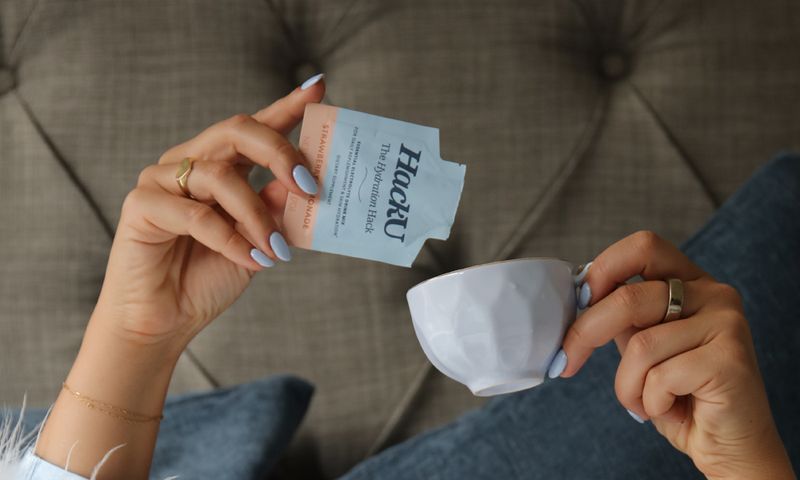 woman pouring HackU into tea cup