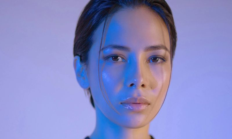 woman portrait against purple backlit background