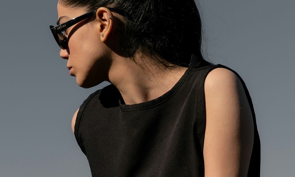 woman in sunglasses outdoors looking to the side