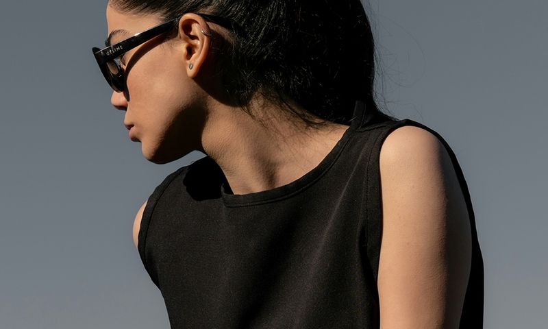woman in sunglasses outdoors looking to the side