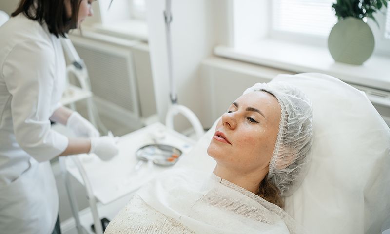 female client waiting for injection procedure for facial rejuvenation