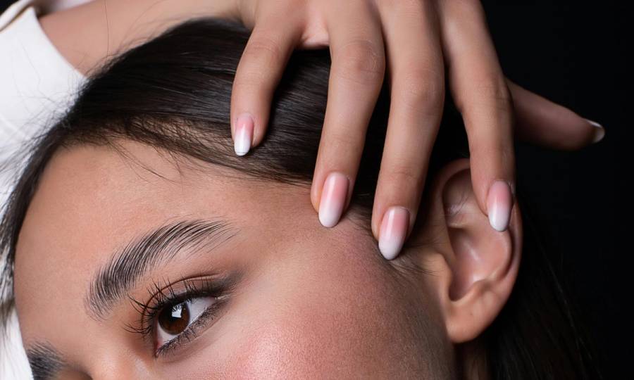 close up of woman's and and nails on her head