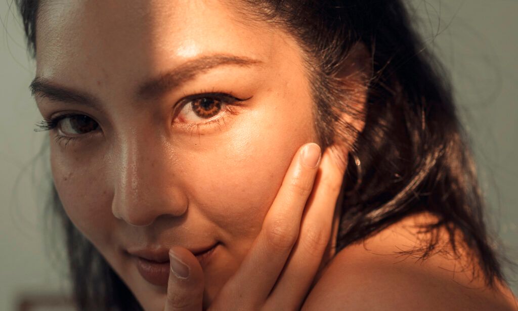 portrait asian female young adult feeling relax on cozy bed after wake up in the morning
