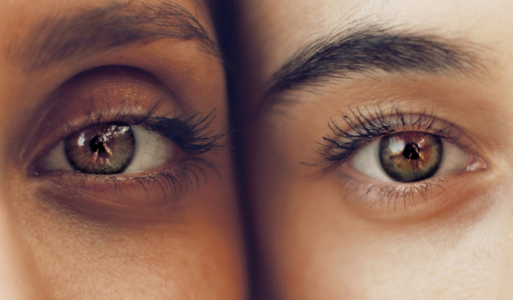 Close-up of a person's eye with clear, healthy-looking hazel eyes and full lashes.